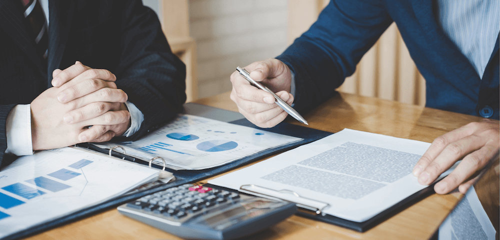 businessmen discussing budgeting i.e translation budget