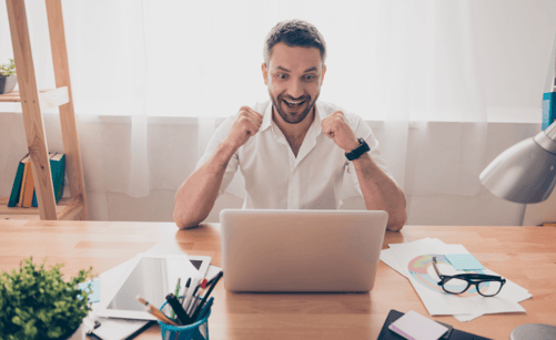 happy businessman looking at a computer screen