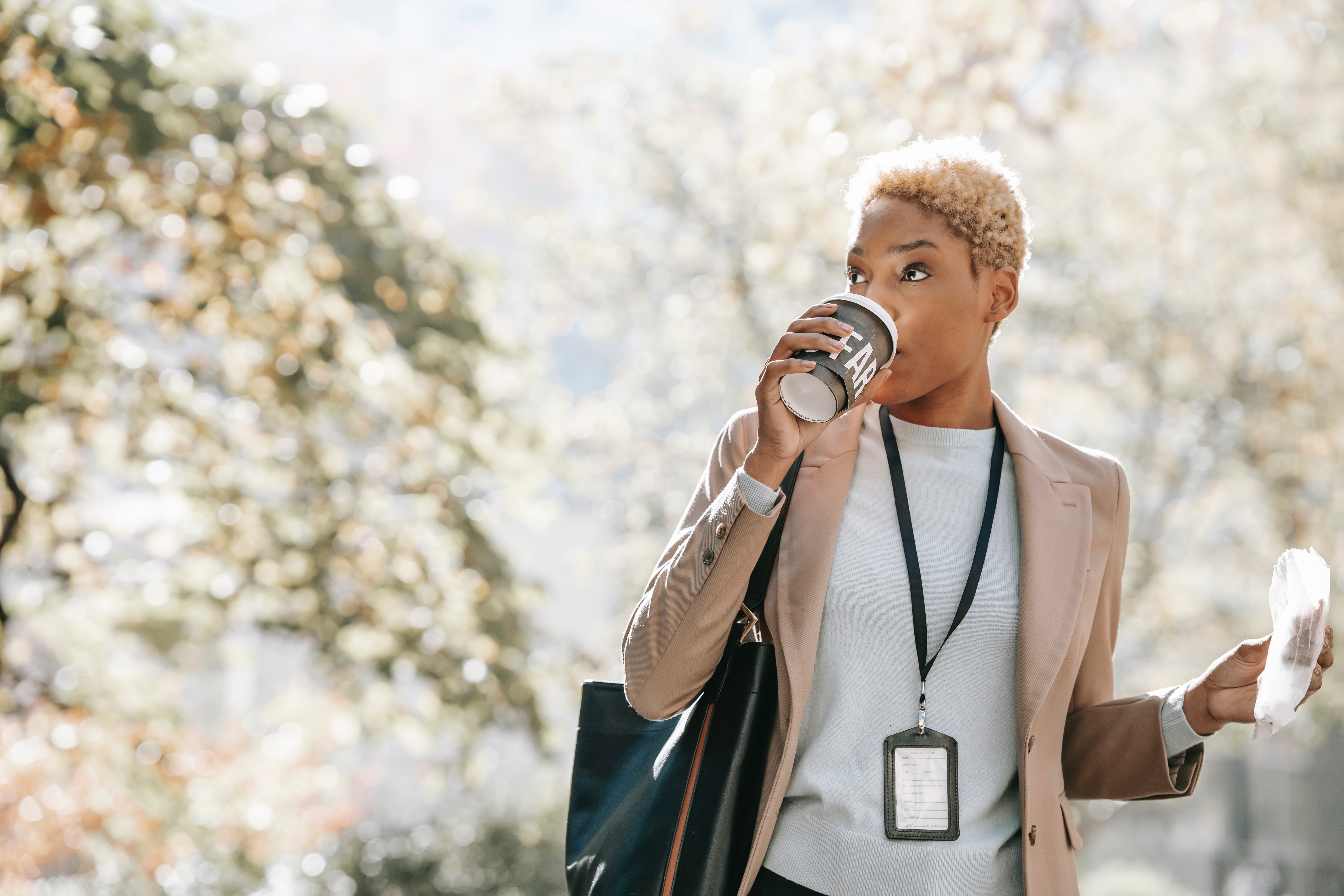 business woman drinking coffee in the park